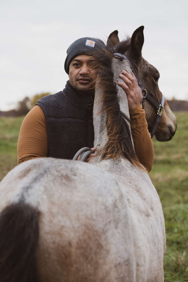 Man hugging colt